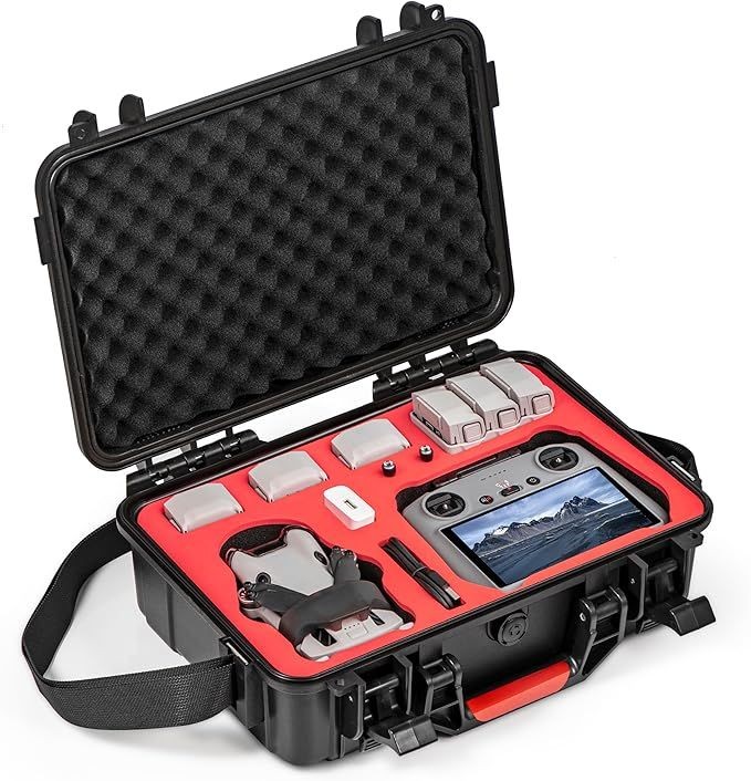 Open black case with drone, controller, and accessories organized in red foam compartments.