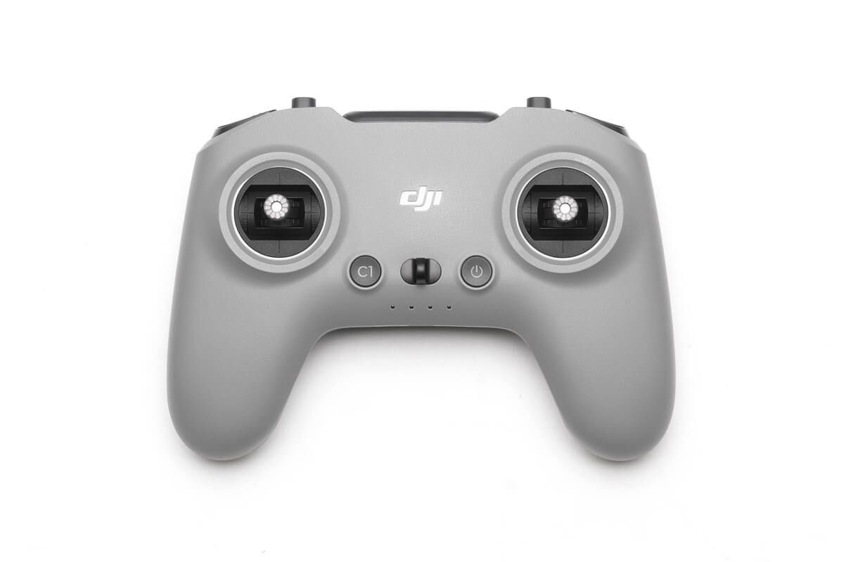 Top view of a gray drone controller with dual joysticks and buttons on a white background.