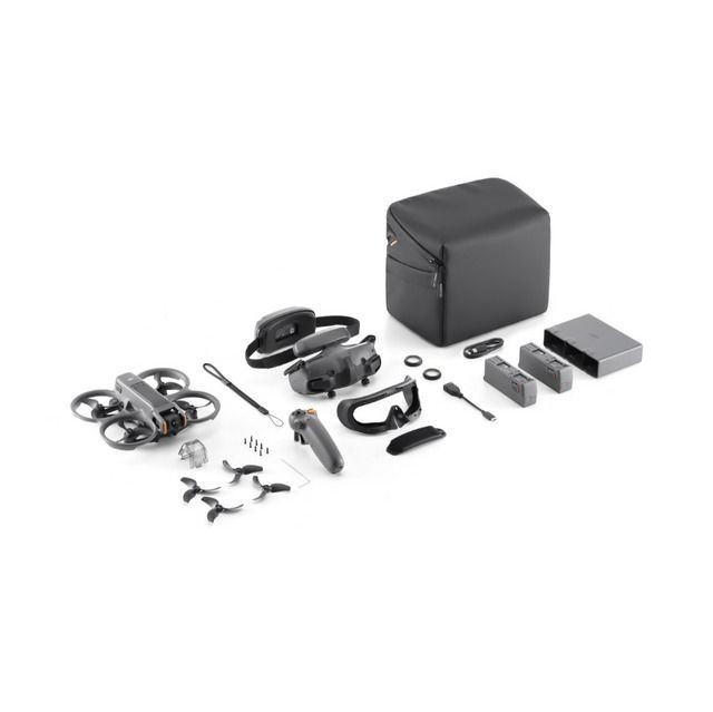 Drone kit with accessories including controller, batteries, propellers, and carrying case on white background.