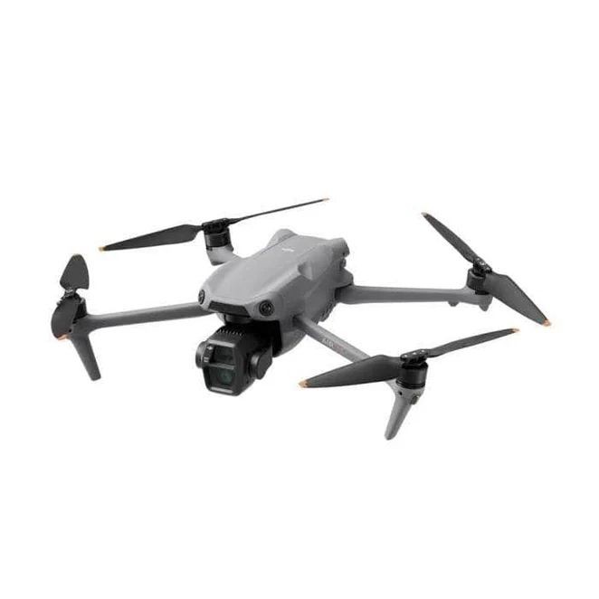 Gray quadcopter drone with a mounted camera and four rotors, viewed from an angle.