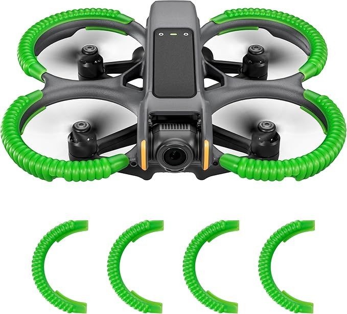 Black drone with green propeller guards and replacement parts.