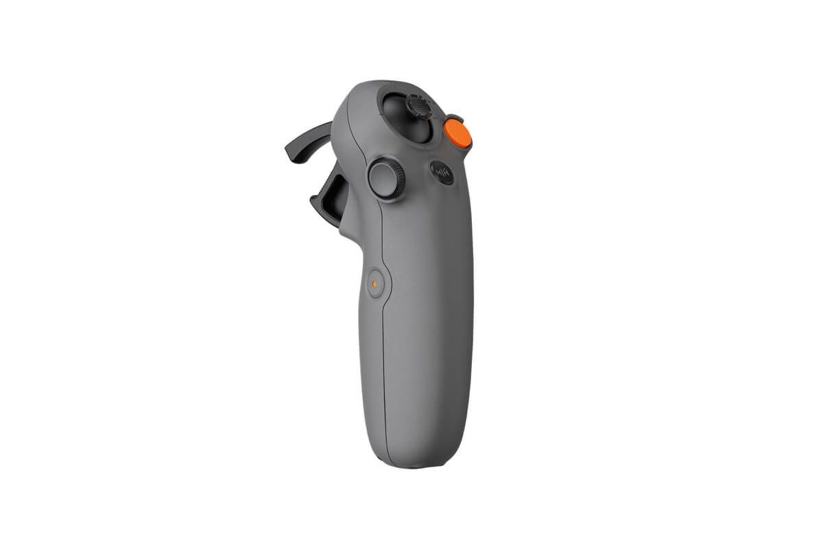 Side view of a gray joystick with multiple buttons and triggers on a white background.