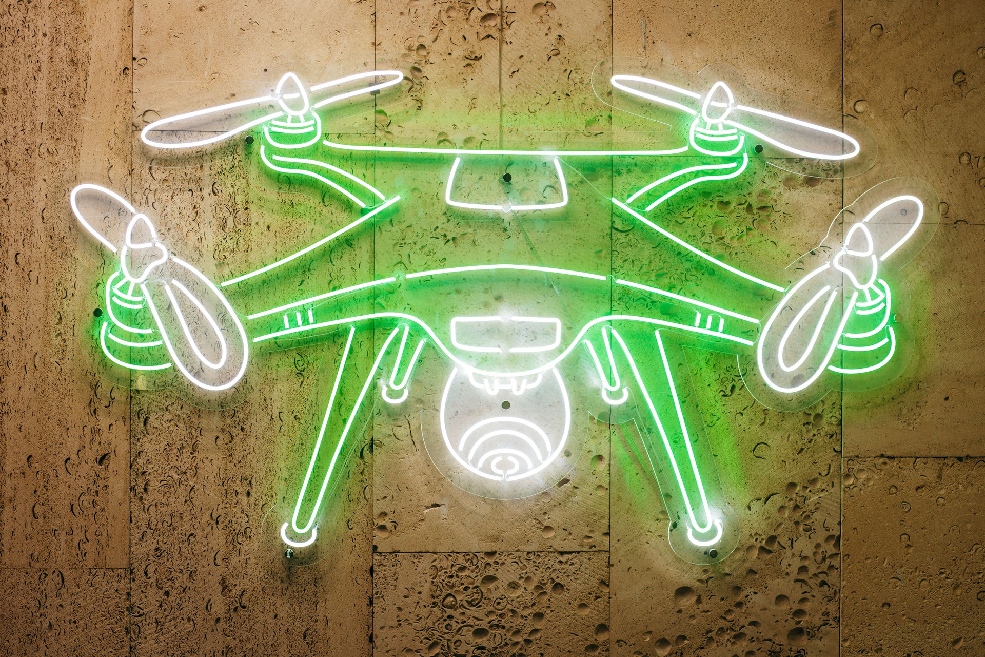 Neon image of drone on the wall